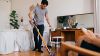 Man vacuuming home 